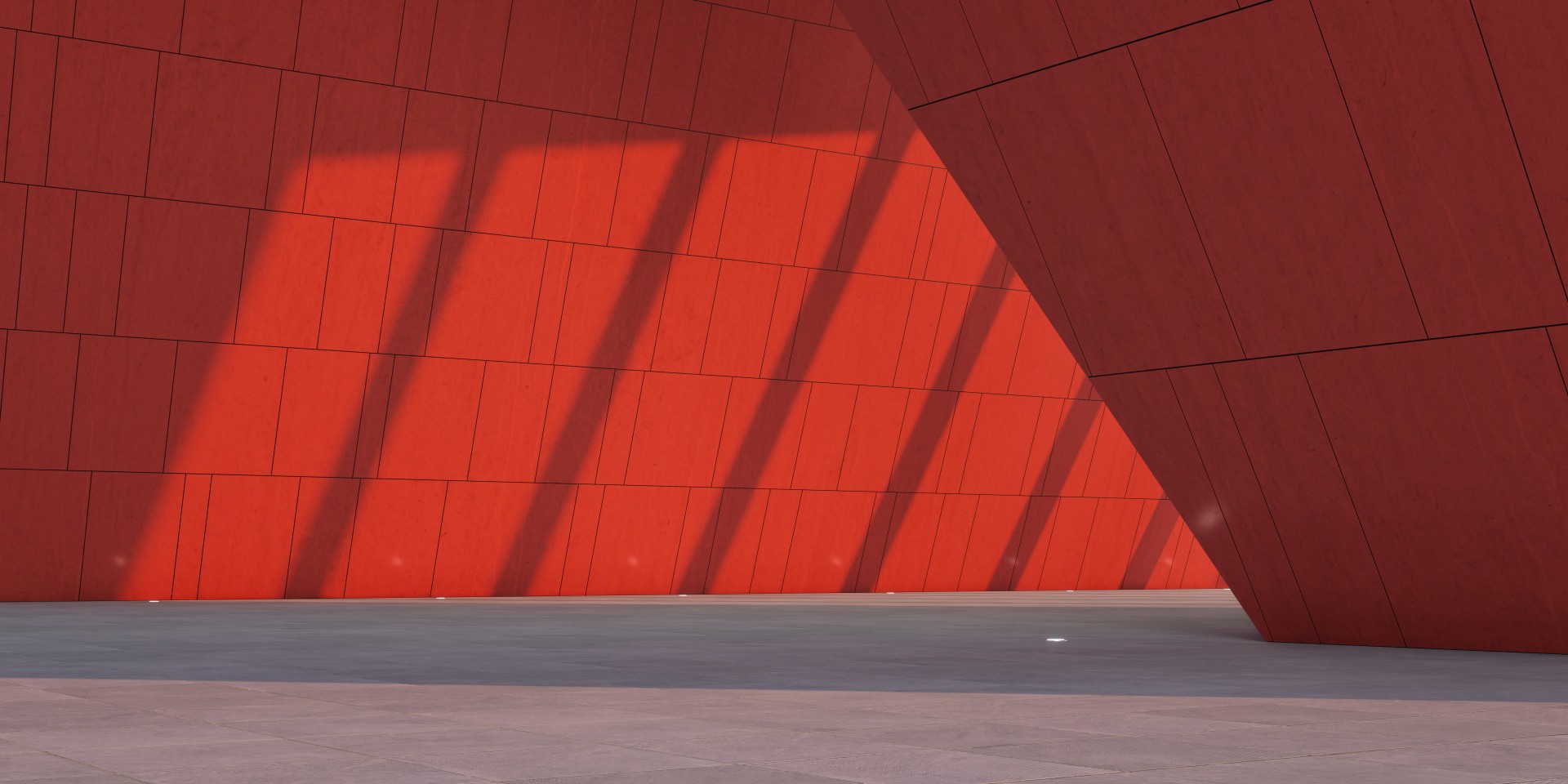 Punainen seinä, jossa näkyy valon ja varjon eroja.